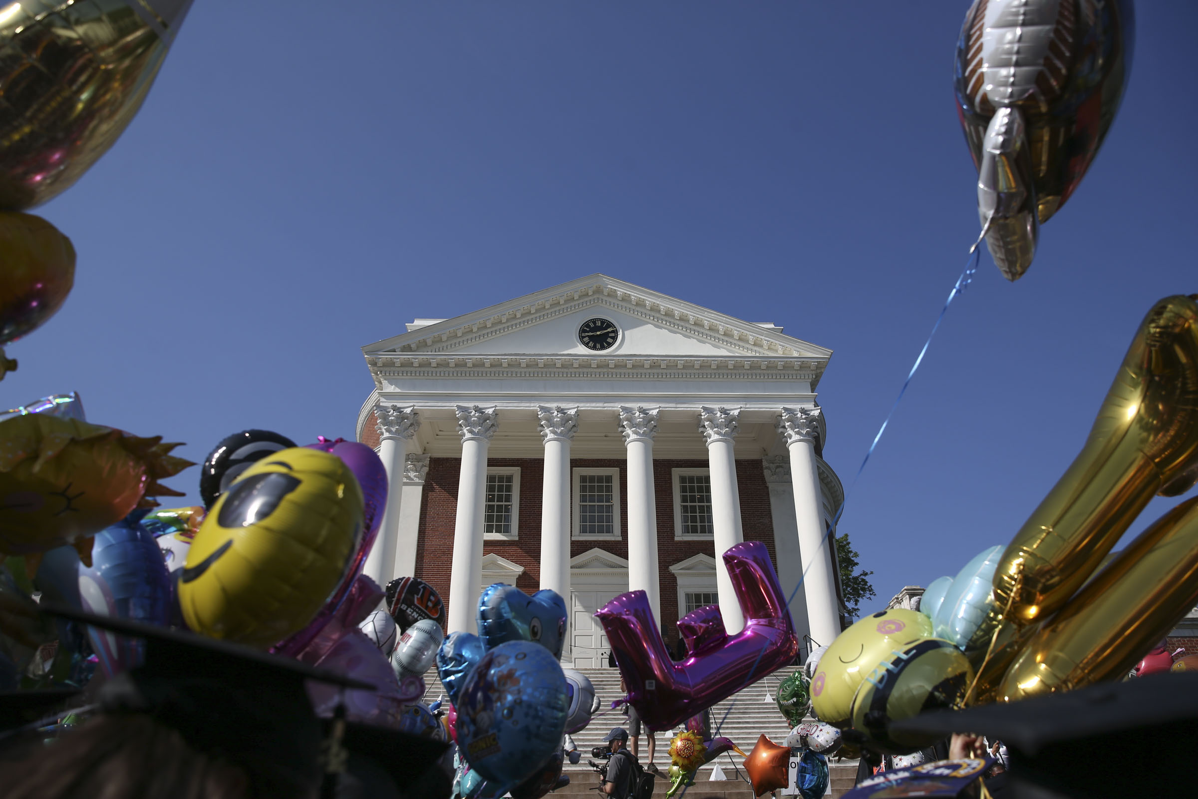 Colorful balloons frame the UVA Rotunda under clear, blue skies.