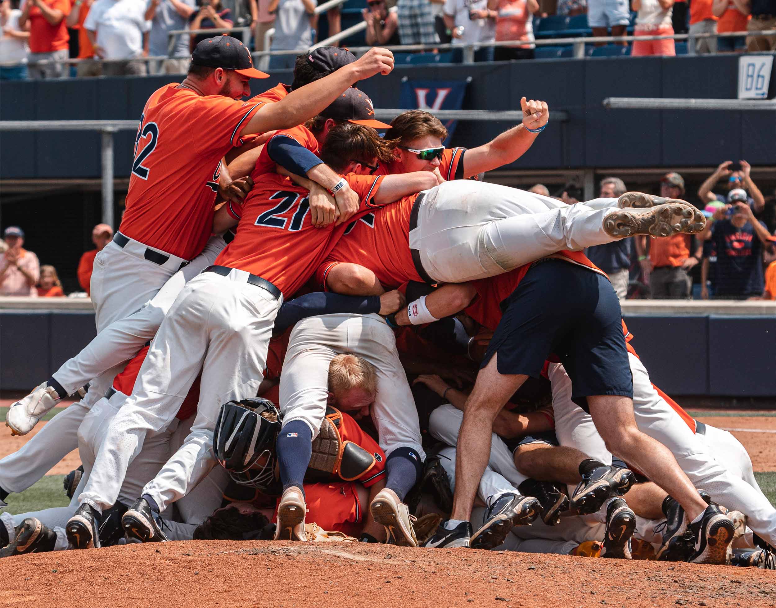 Baseball players mid pile up on the field