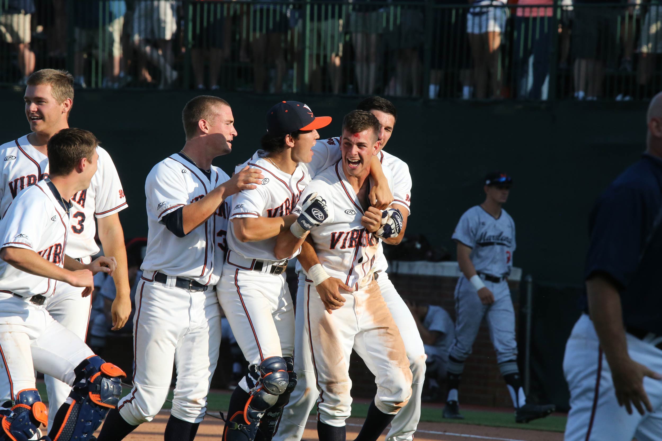 Ernie Clement celebrating with the UVA baseball team after a victory