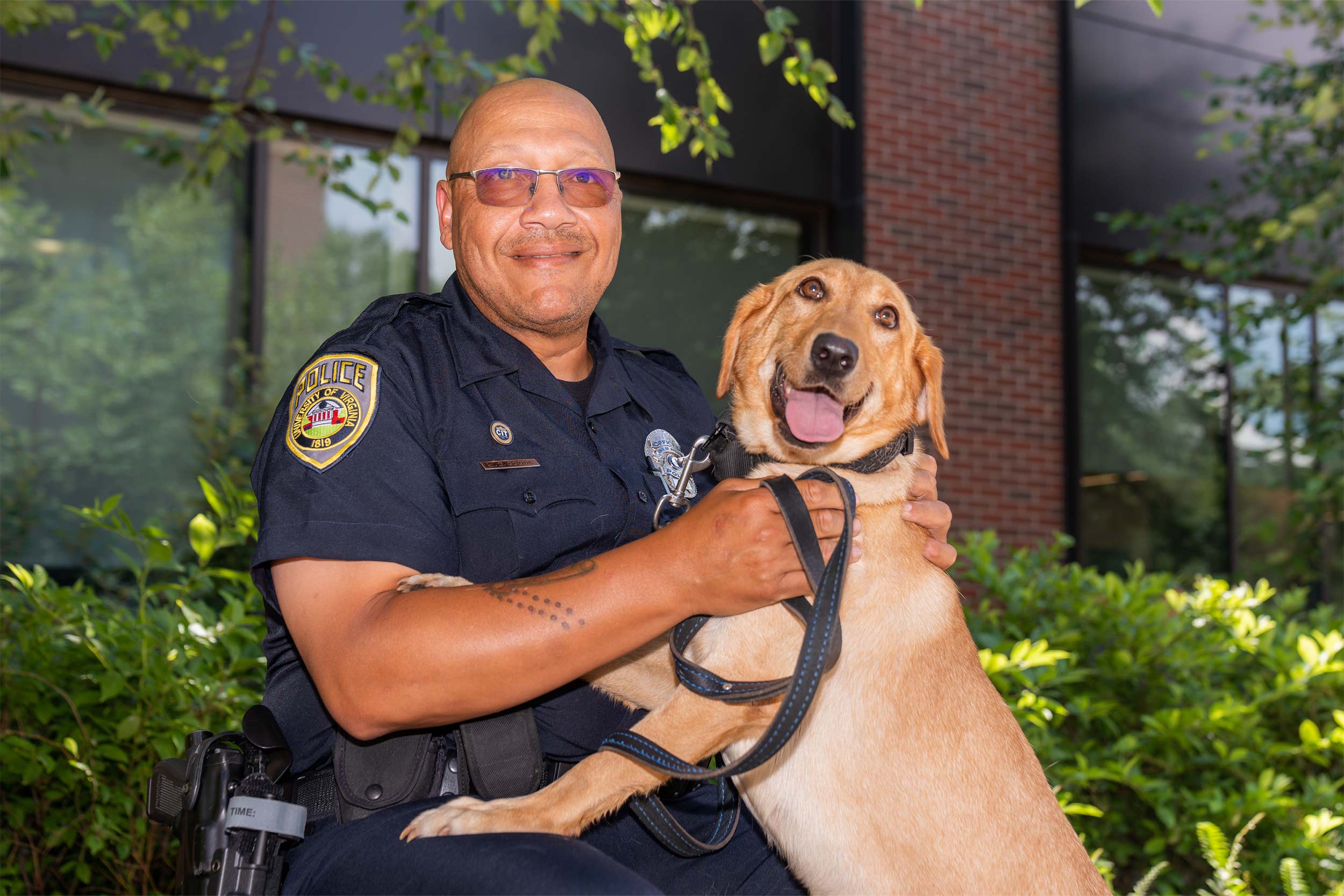 Portrait of Officer Wallace Goode and a golden lab