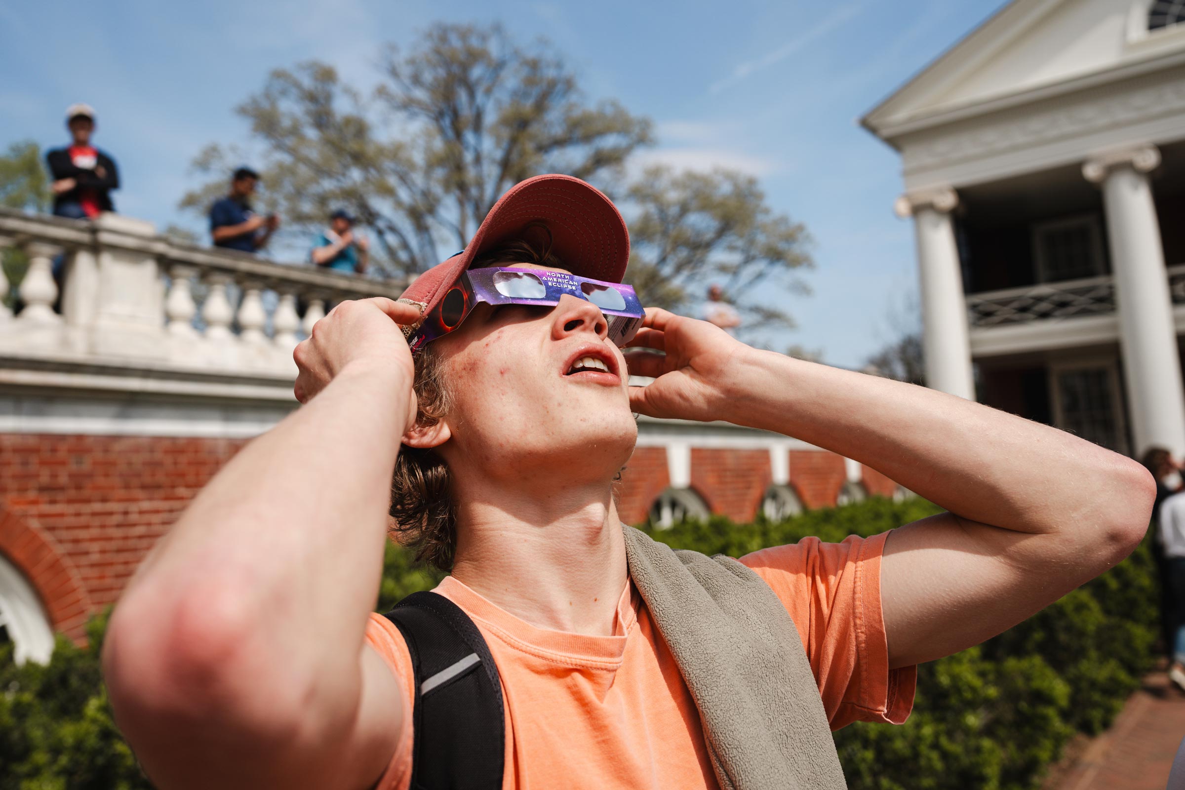 Guy gazes at solar eclipse with glasses