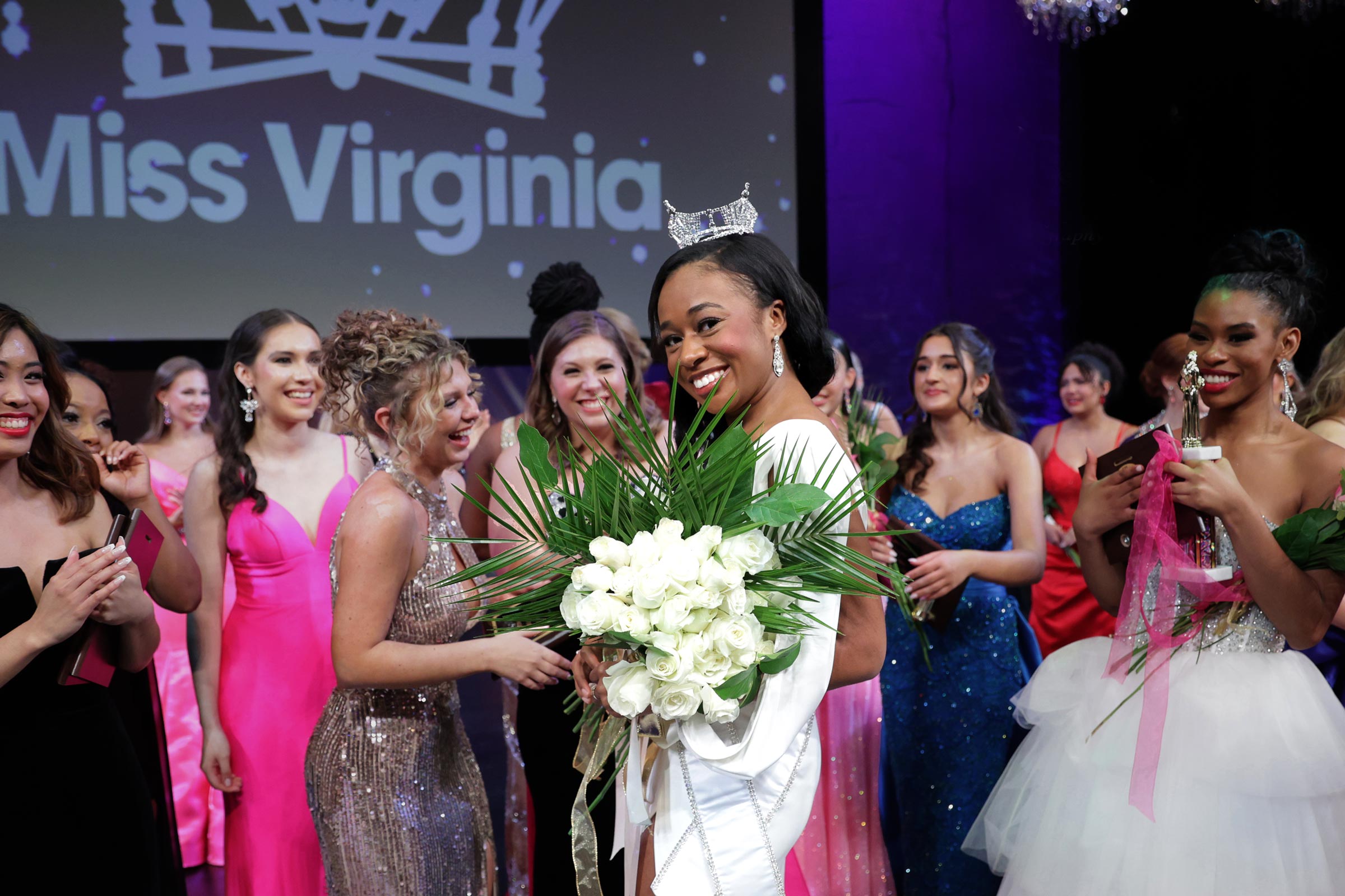 Carlehr Swanson holding her bouquet of flowers and smiling for the camera