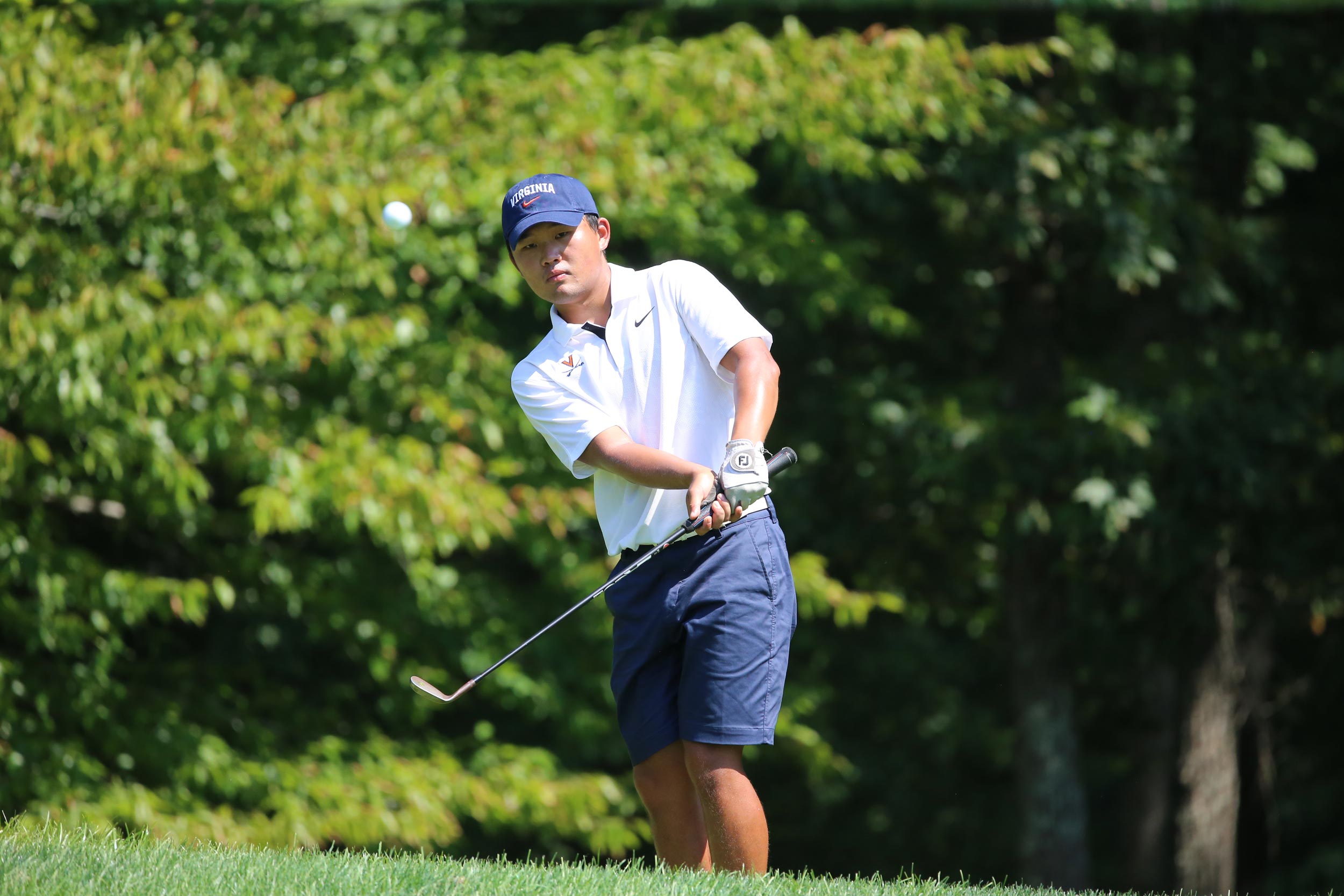 Paul Chang on the golf course right after making contact with the ball