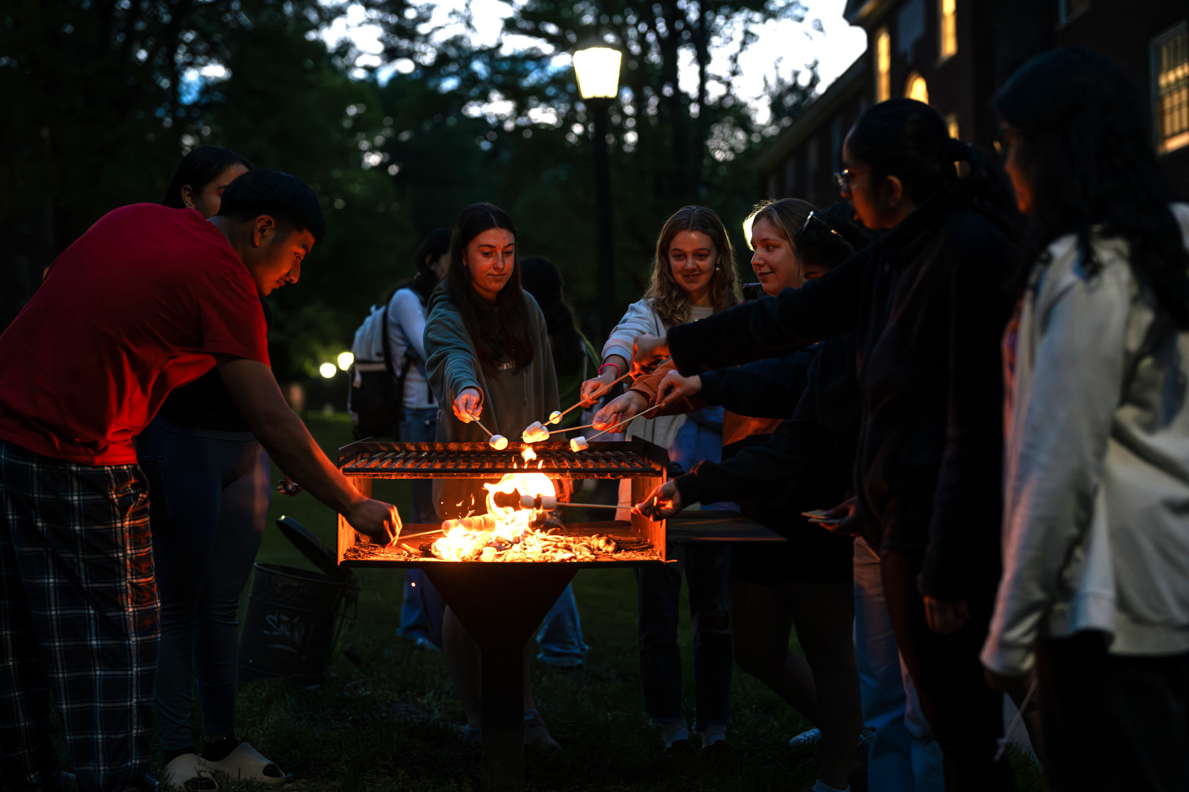 Dao Tran making smores with residents of her community