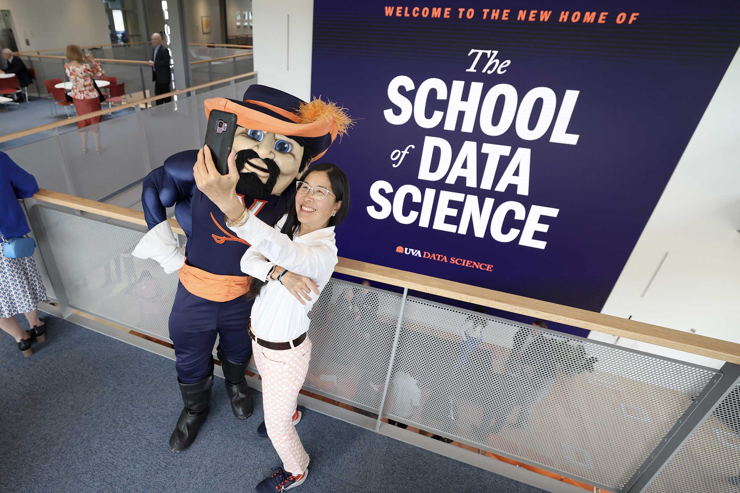 Cavman and a student in front of the new data science banner