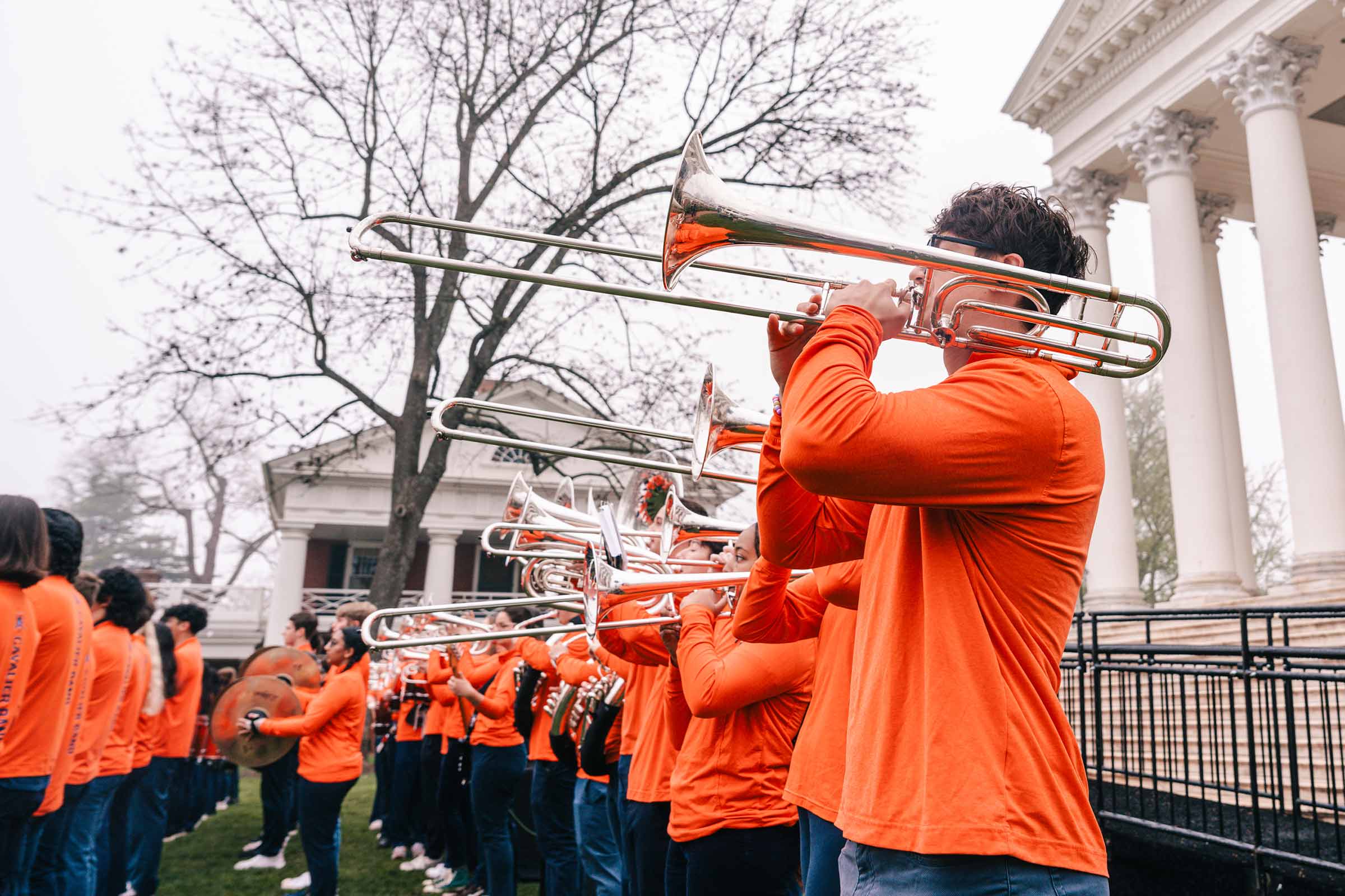 Trombone player stands in a row of fellow band members