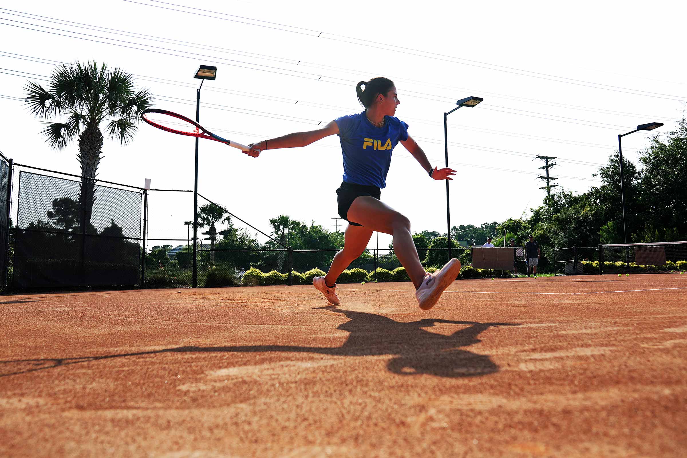 A candid photo of Emma Navarro in action on the tennis court.