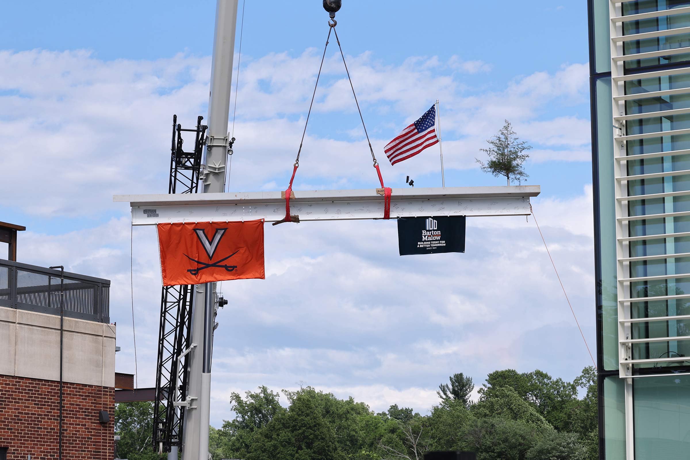 The final steel beam is placed atop the Harrison Family Olympic Sports Center, which is scheduled to open next summer. The building, which will accommodate UVA’s Olympic sports programs, is named for the family of the late Mary and David Harrison III, two of the University’s most generous benefactors.