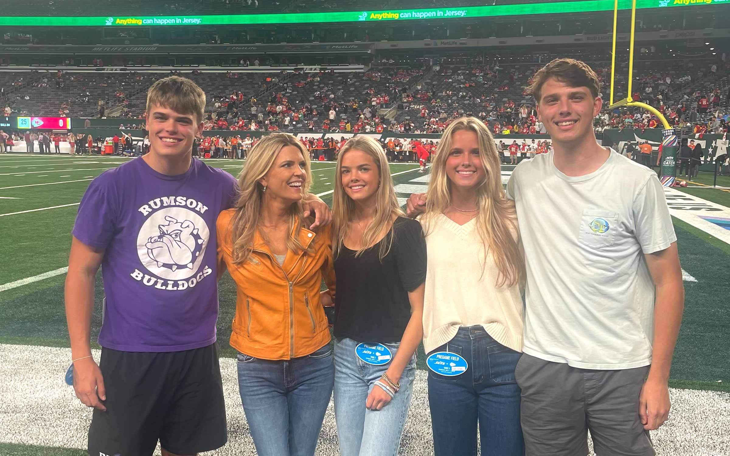 Melissa Stark and her family on the field at a football game