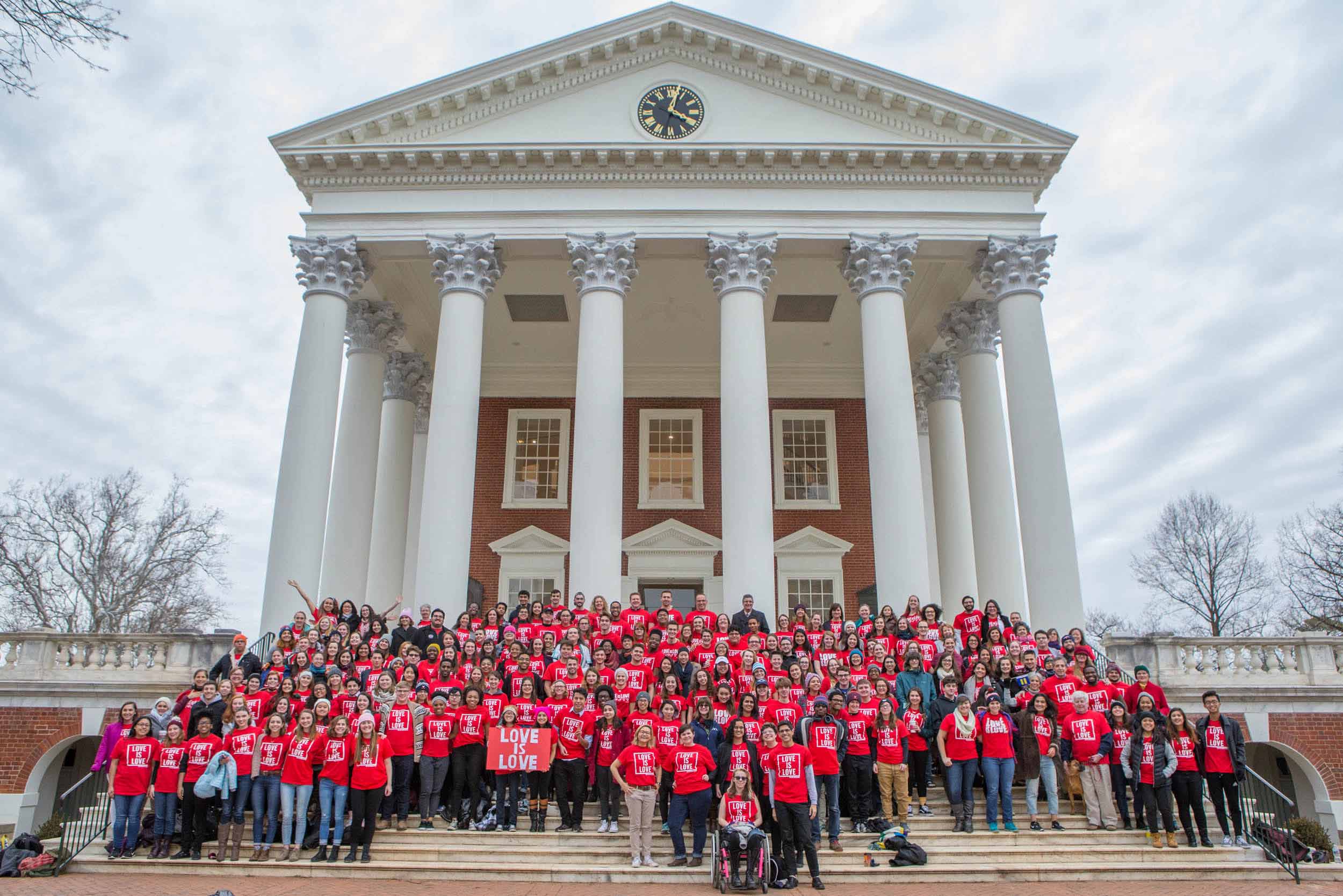 Aaron Laushway with many students, faculty, and staff out side the Rotunda wearing red “Love is Love” shirts
