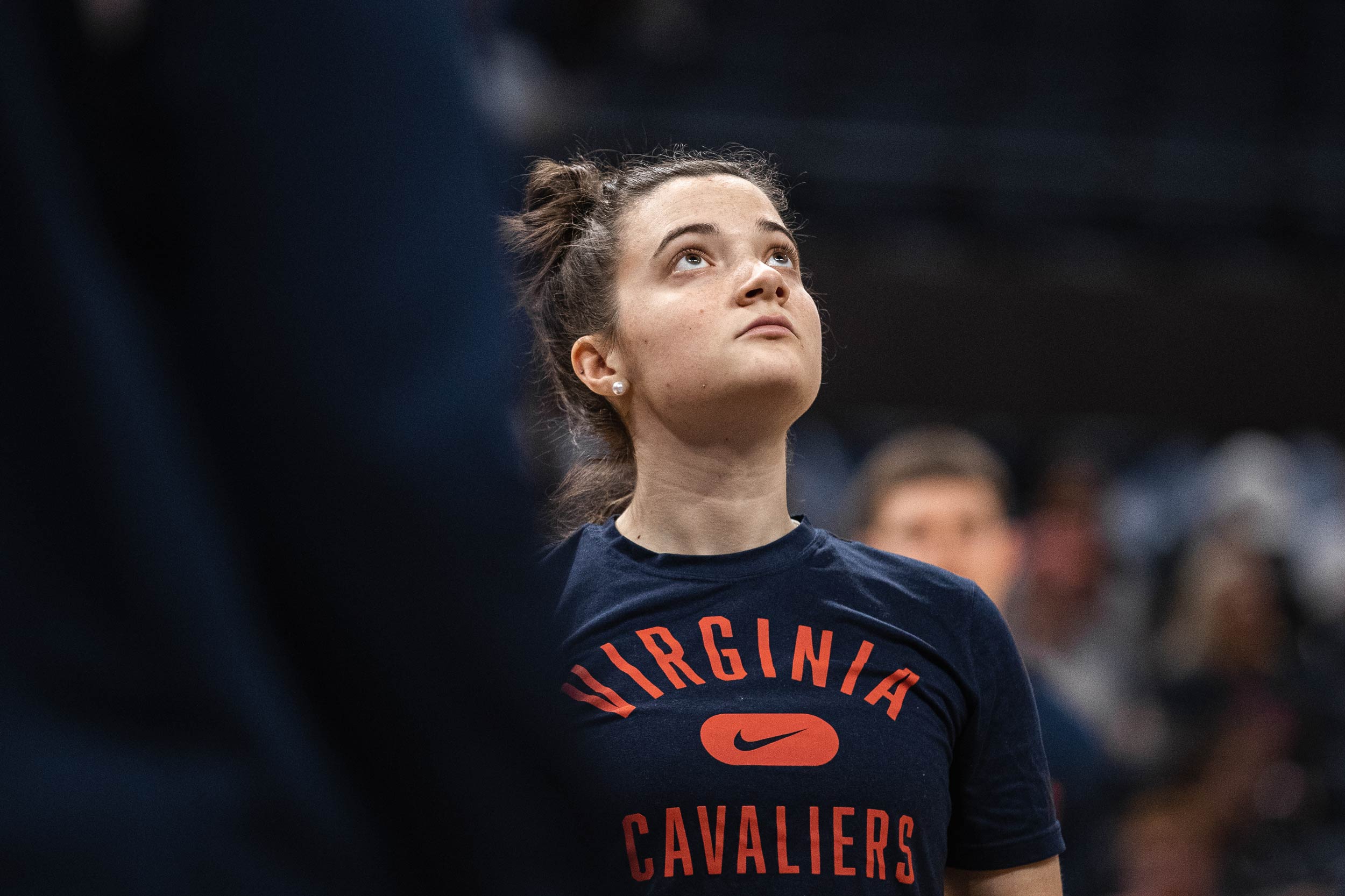 Anna Williamson  in a Virginia Cavaliers tee shirt looking up