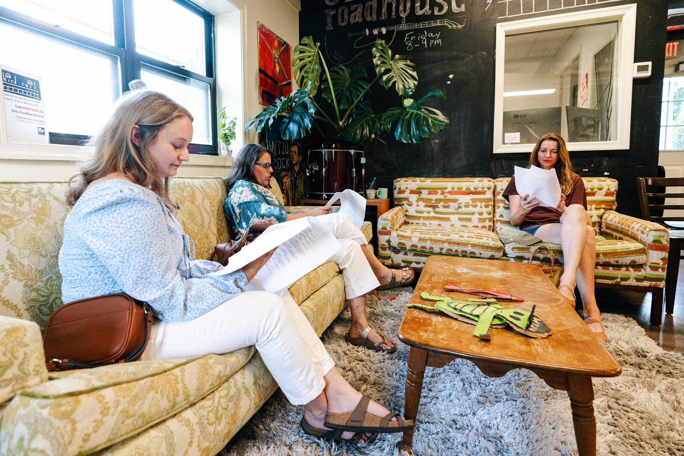 Charlottesville residents and UVA students, who acted in the audio dramas, sit on couches in the studio