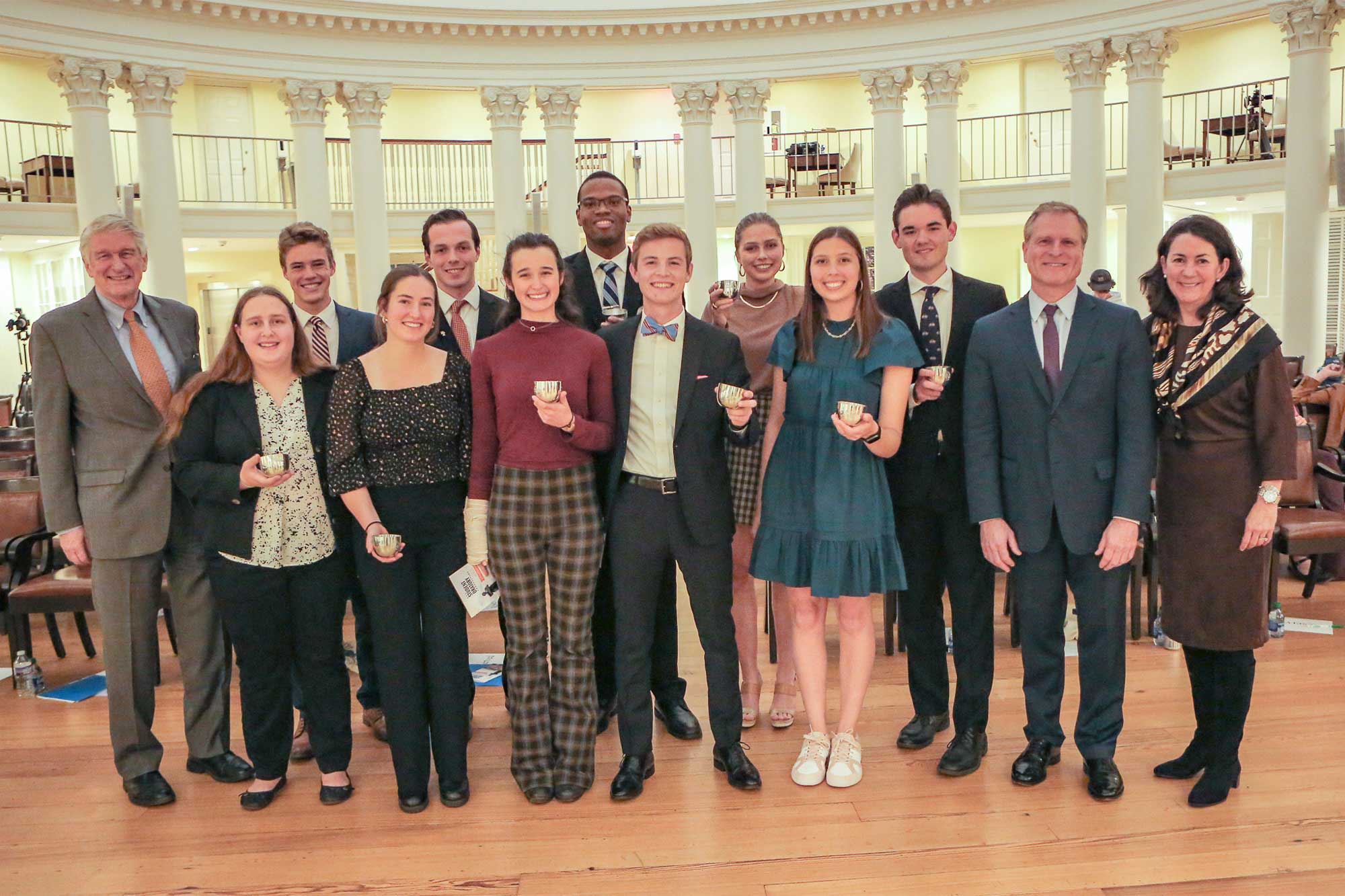 Group photo of the Oratory Content Group holding cups and smiling at the camera