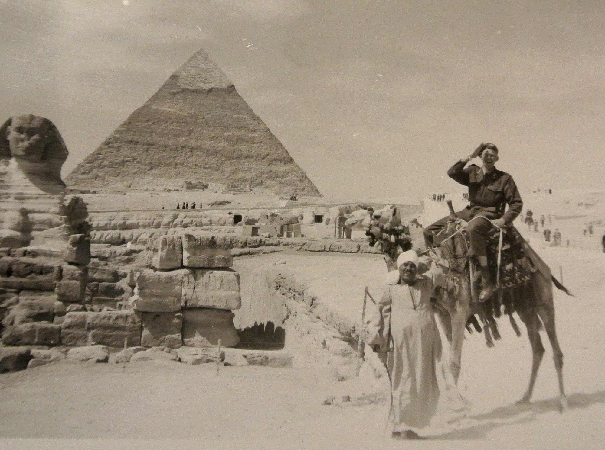 Dr. Hans Riddervold aboard a camel near the Sphinx at the Great Pyramid of Giza