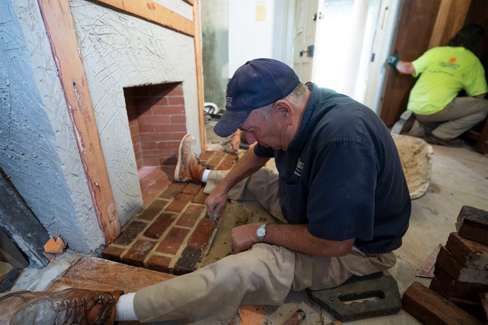 Drew Shelton sits in front of a fireplace, replacing the brick hearth.