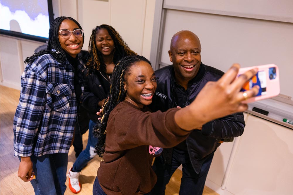 group takes selfie with Leland Melvin