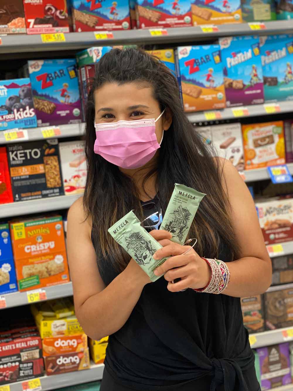 Coco Sotelo in a grocery store showing to Mezcla bars
