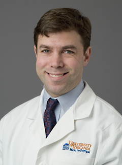 Portrait of Kenneth Bilchick in white lab coat and tie