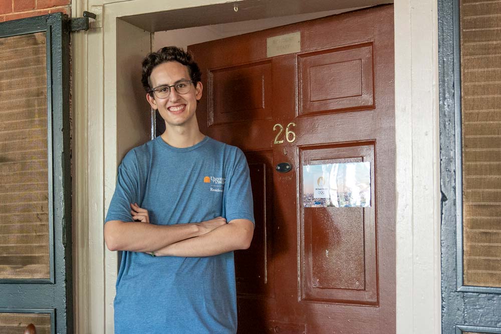 Owen Selden, the senior resident of the Lawn, takes a pause from doling out keys and bathrobes to his fellow Lawnies on Friday morning for a quick photo. 