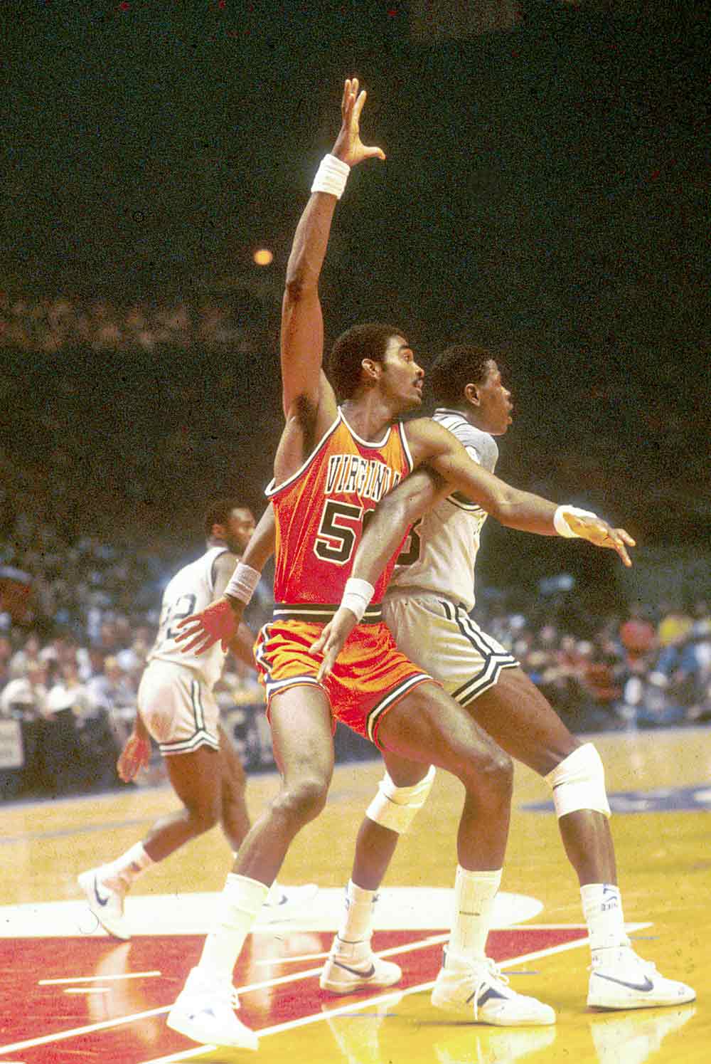Ralph Sampson and Ewing blocking each other during a game