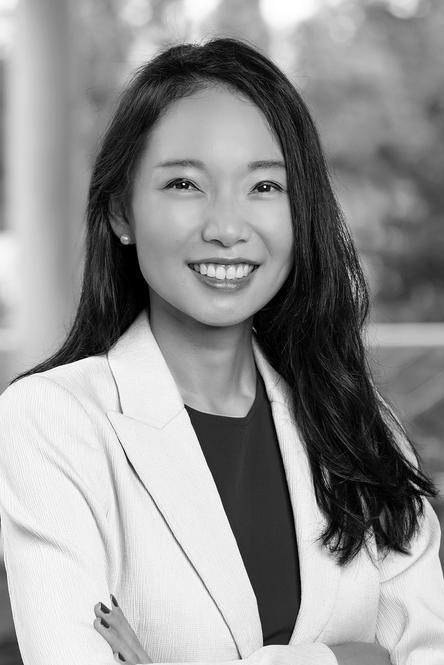 A smiling woman in a white blazer