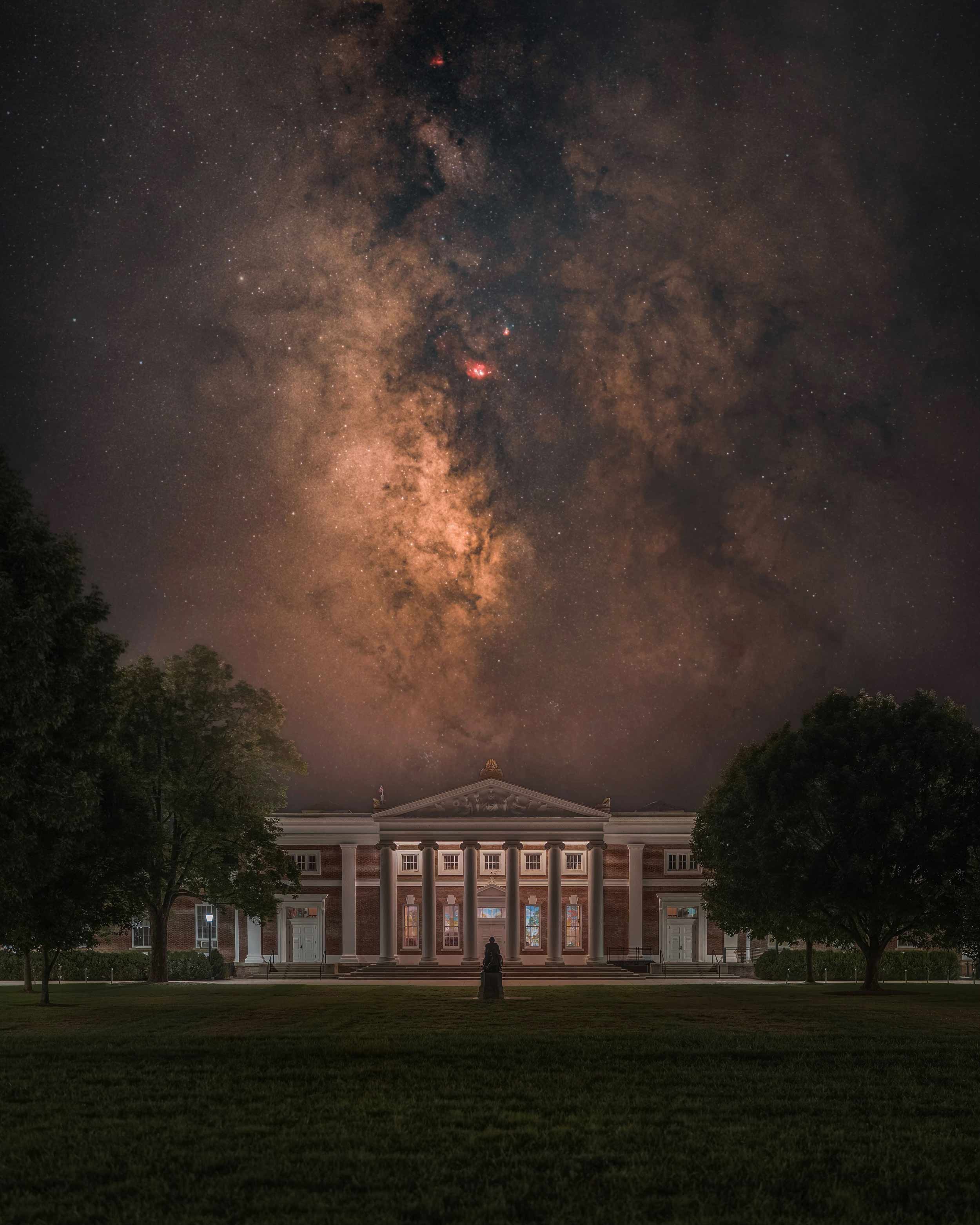 The dark and light gaseous clouds of the Milky Way Galaxy are prominent in the night sky over Old Cabell Hall