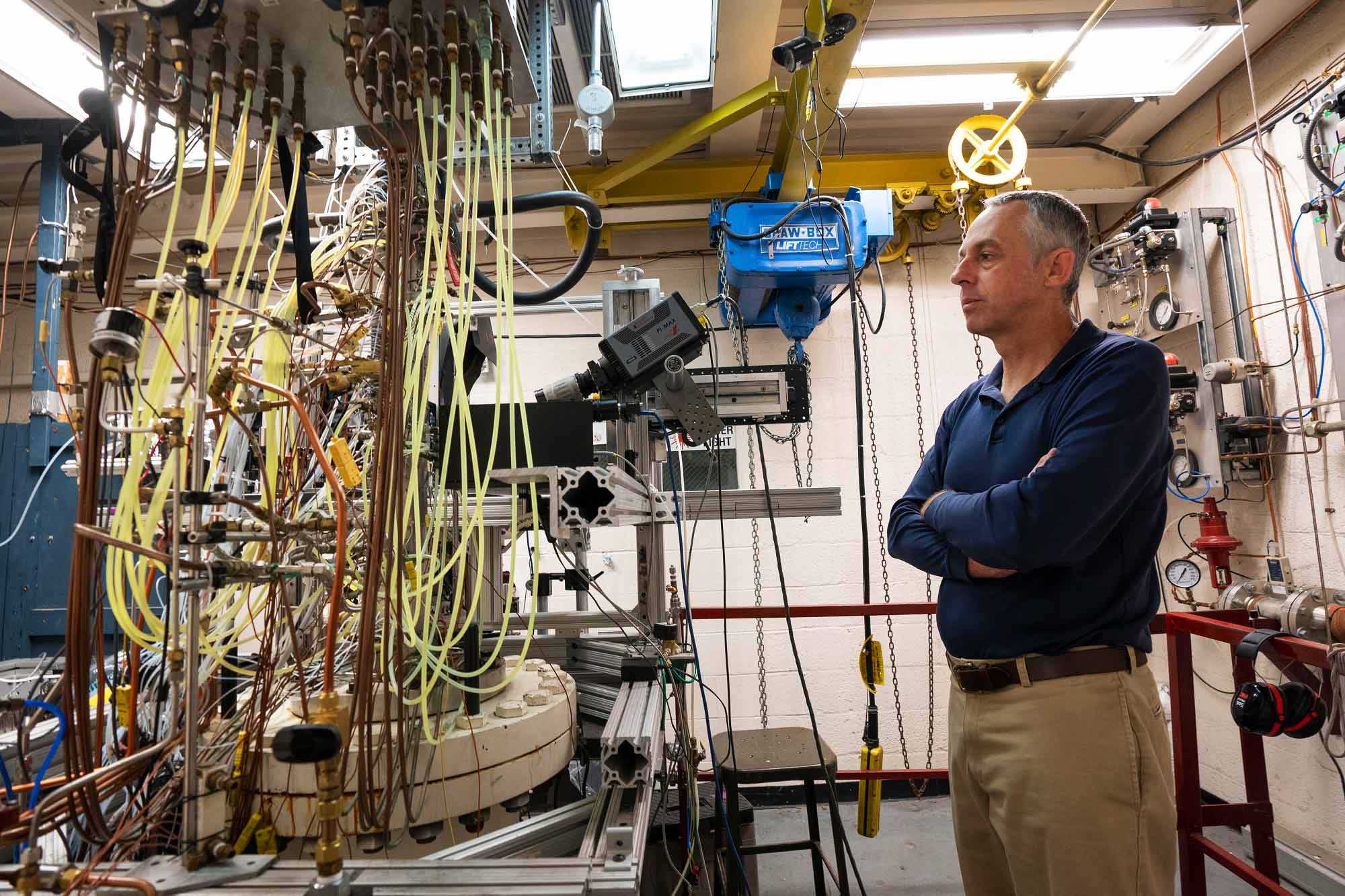 Christopher Goyne, professor and director of UVA's Aerospace Research Laboratory, looks over some of the research equipment that he and students use to study hypersonic flight. 