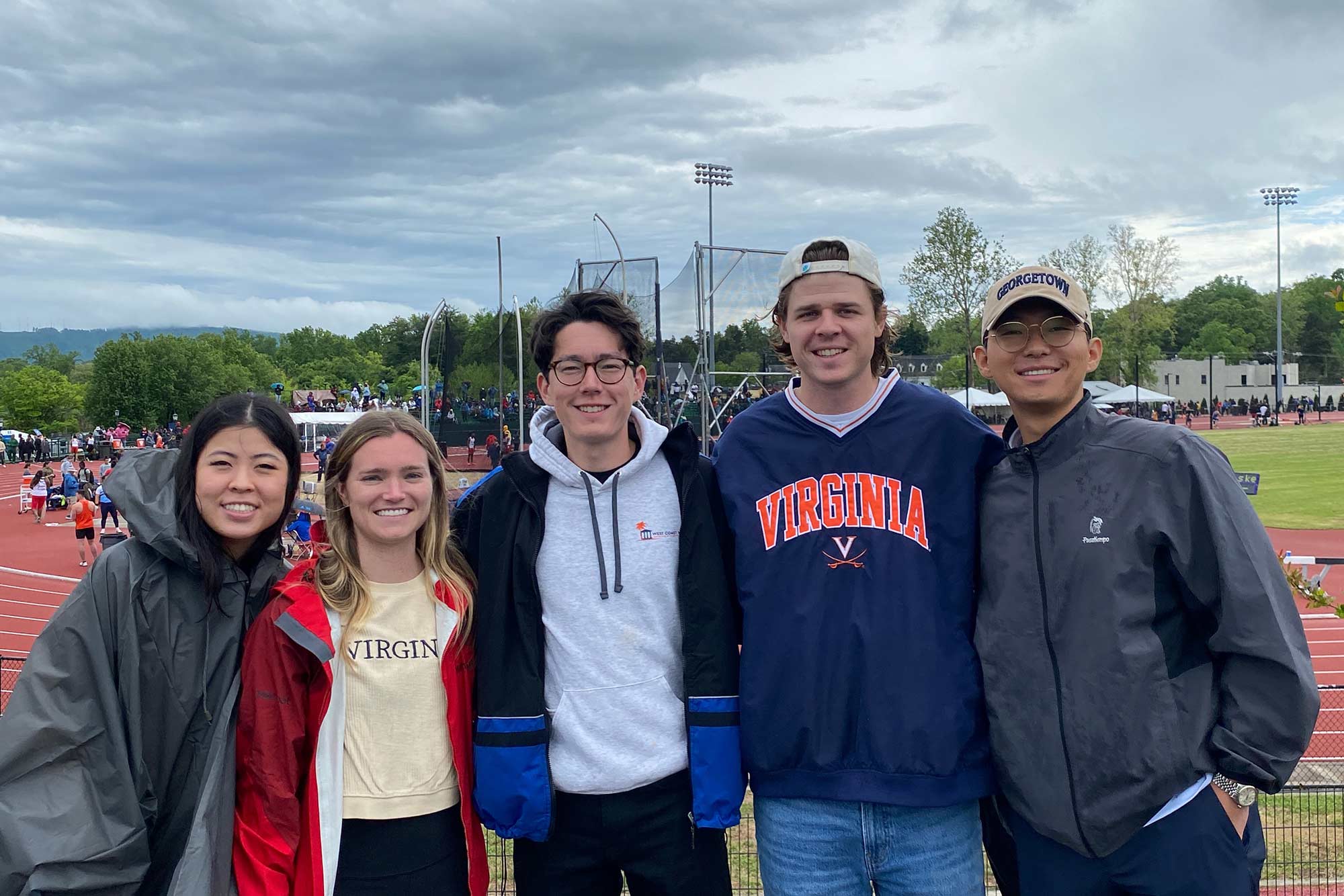 Group portrait of Fun Club members at a track and field event