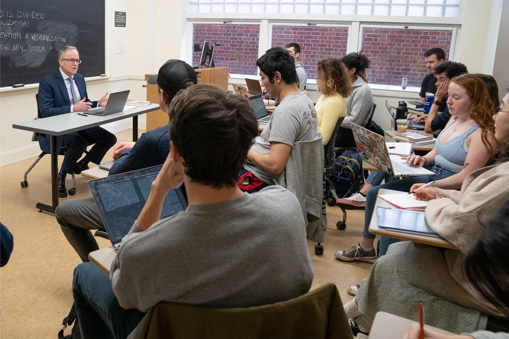 John Owen teaching a class full of students