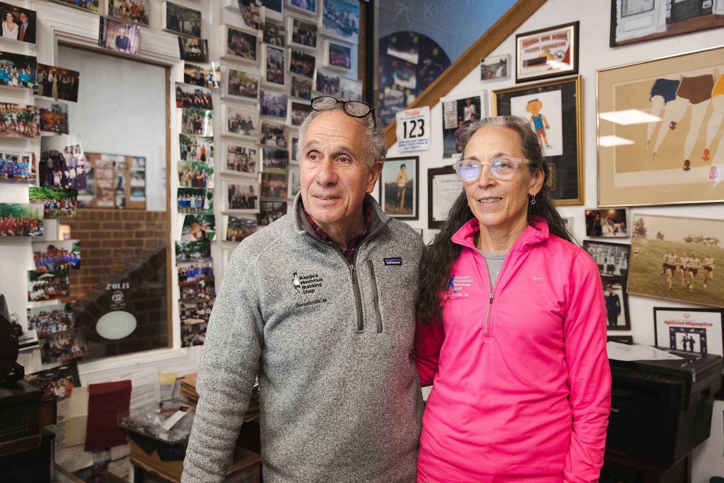 Mark and Cynthia Lorenzoni in an office, the walls of which are covered in photographs