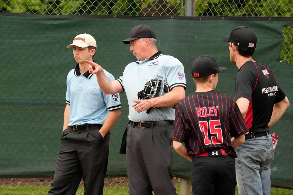 Candid of Brian Helmke with student Jack Liskey at a baseball game