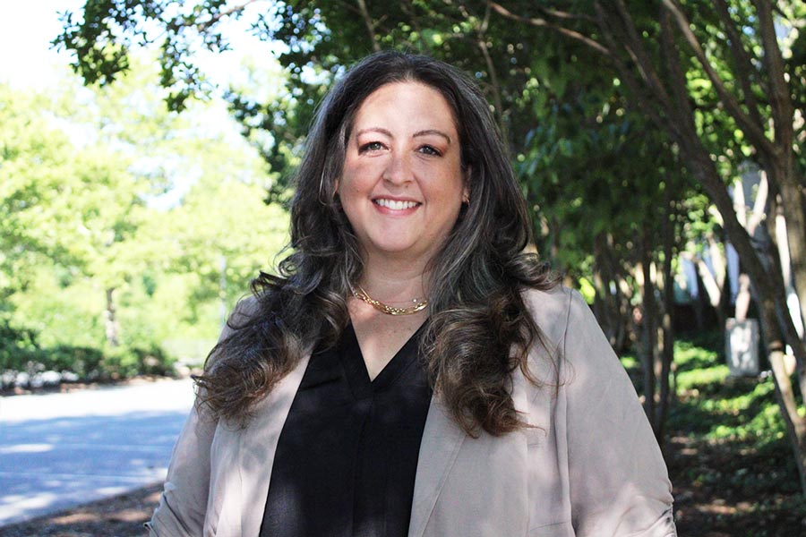 Elizabeth Marshall stands outside smiling for a portrait.