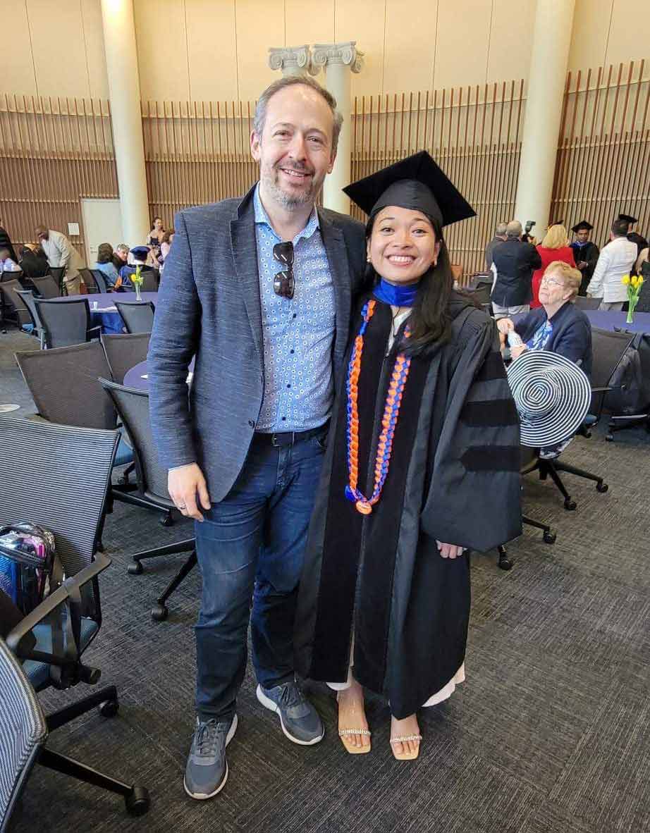 Post graduation candid of UVA’s Andrea Francesca M. Salvador, who just received her doctorate from UVA, stands with former lab director Jonathan Kipnis. 