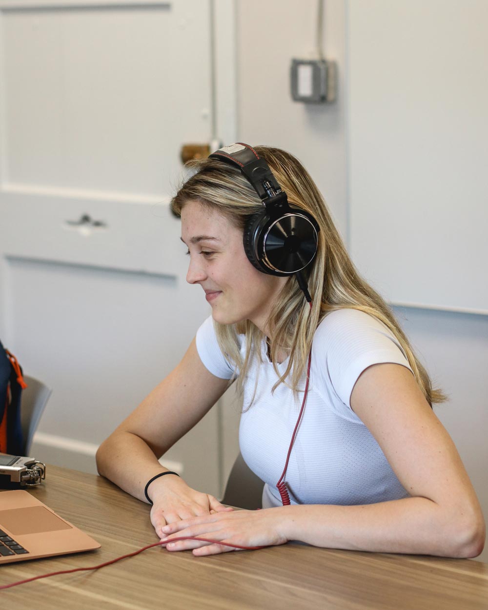 Madison Morey smiling in studio with headphones on recording Inside UVA episode 