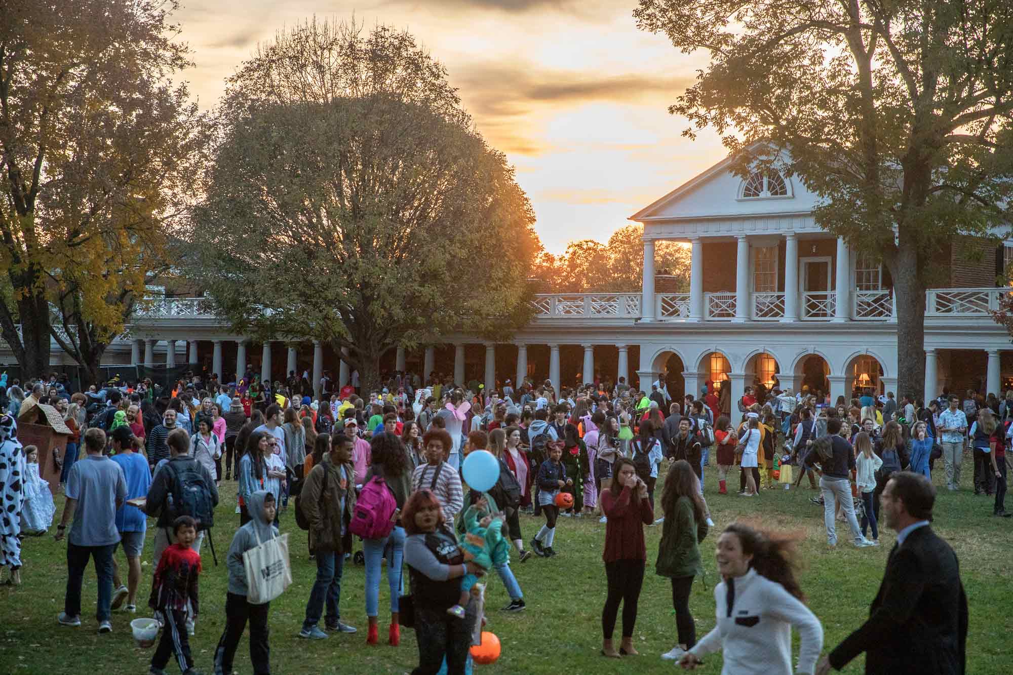 At sunset, the UVA lawn is filled with adults and children dressed in costumes