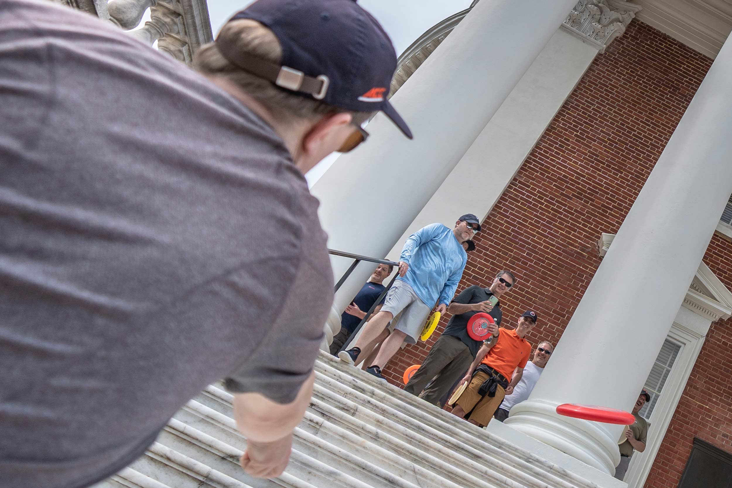C.J. Takacs watching his frisbee go up towards the Rotunda from the bottom of the steps