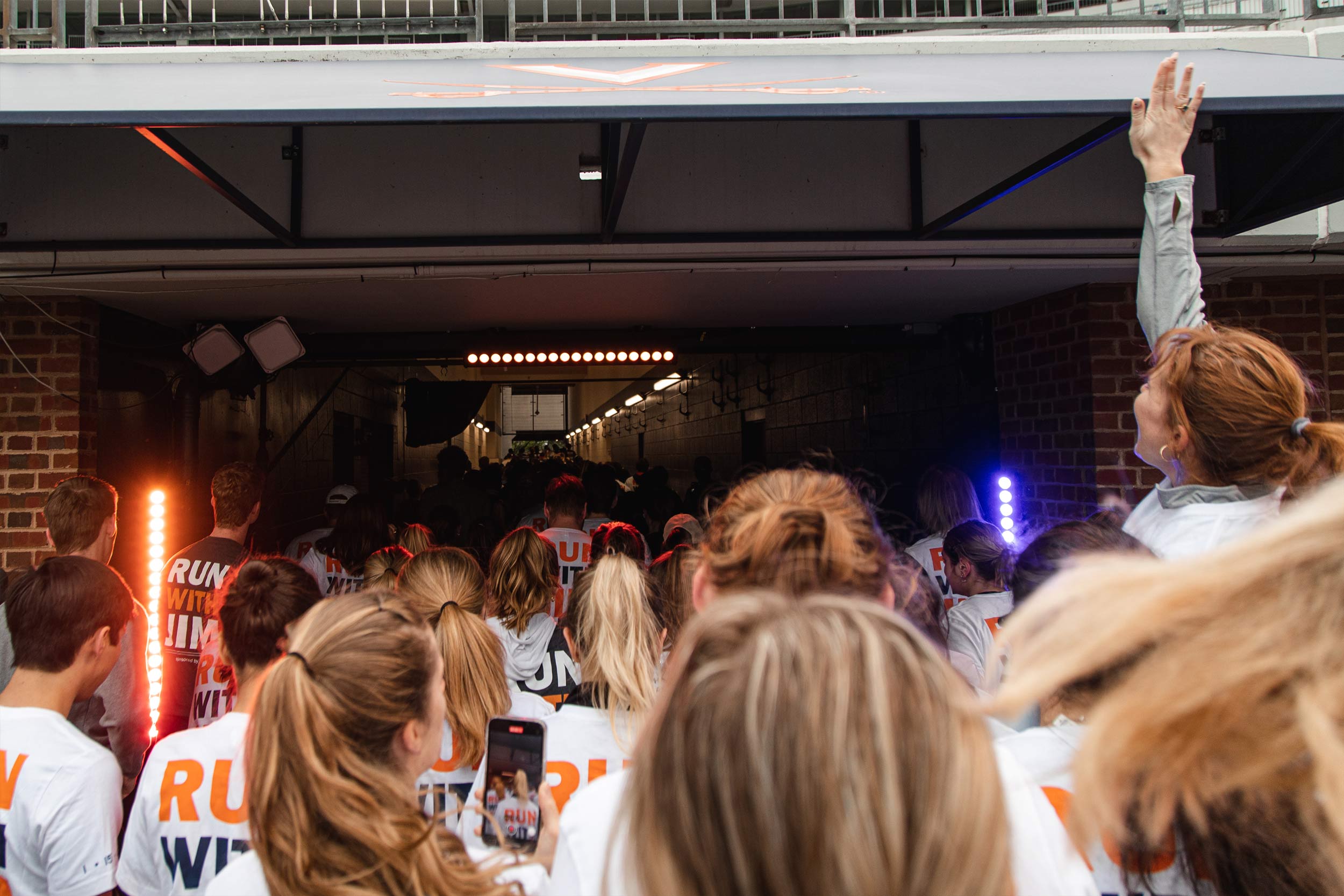 Runners excitedly enter the football teams tunnel to begin the run