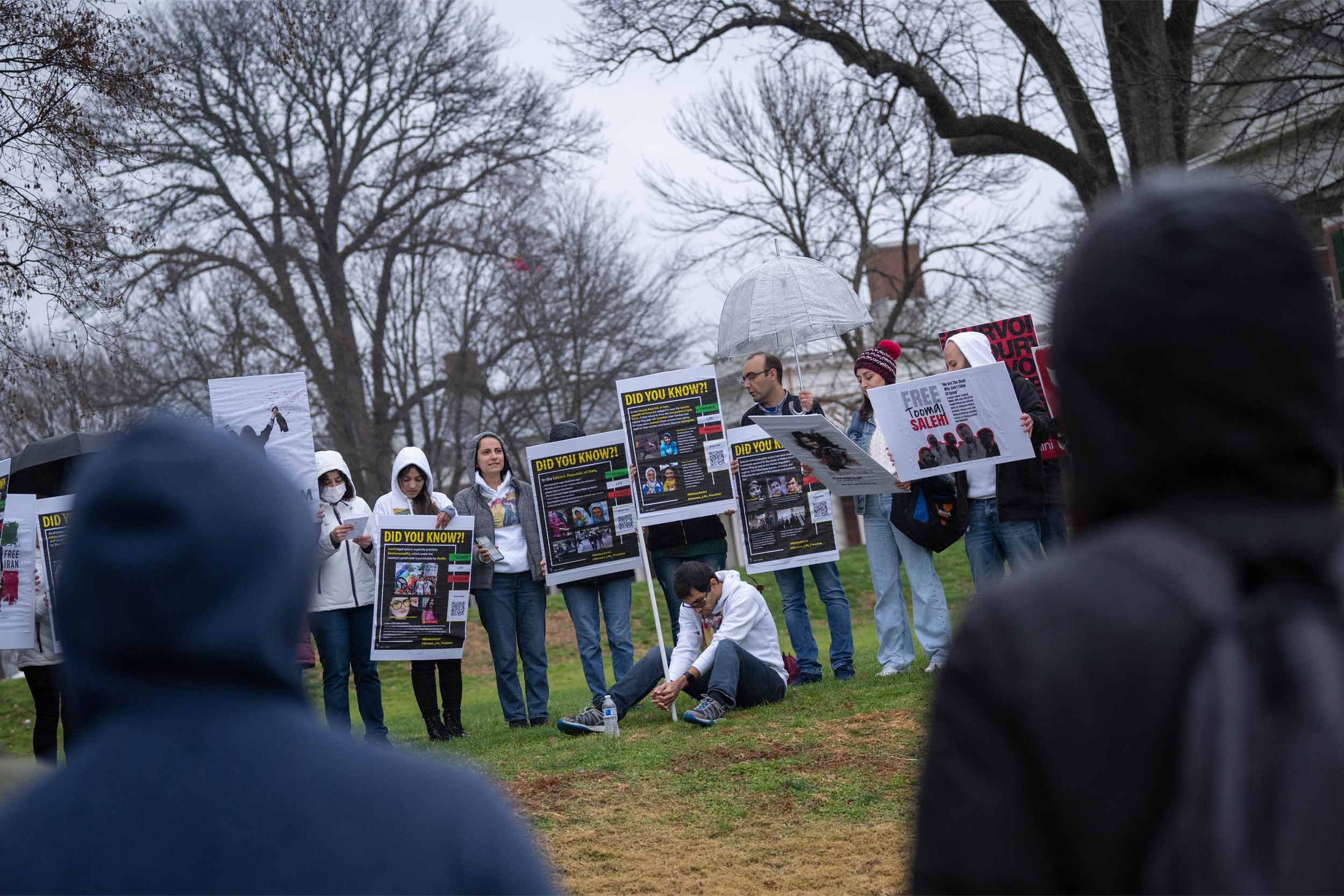 Students protesting holding various signs on the lawn