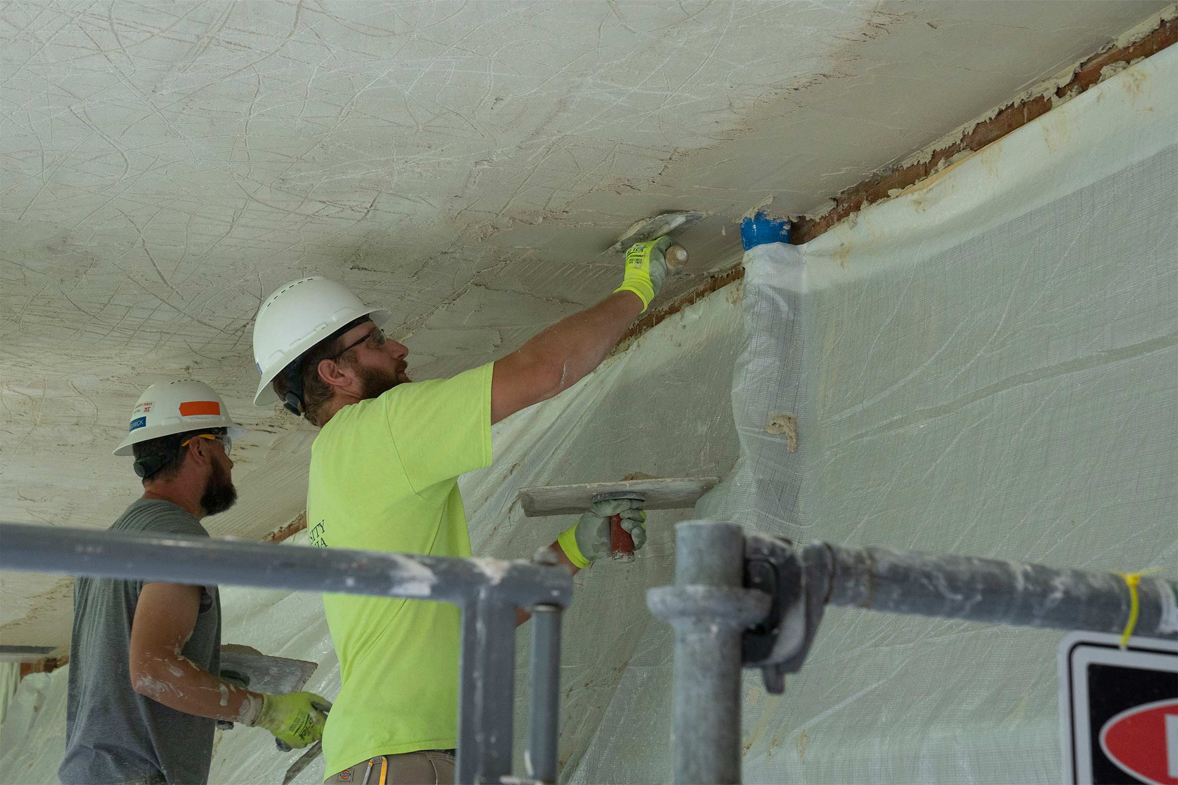 Workers plastering the Colonnade ceiling