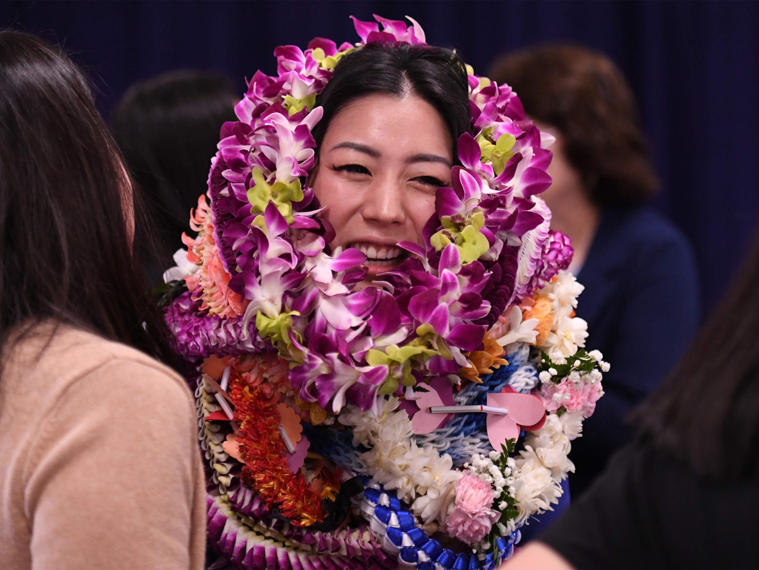Esther Kwon nearly swallowed by ceremonial leis