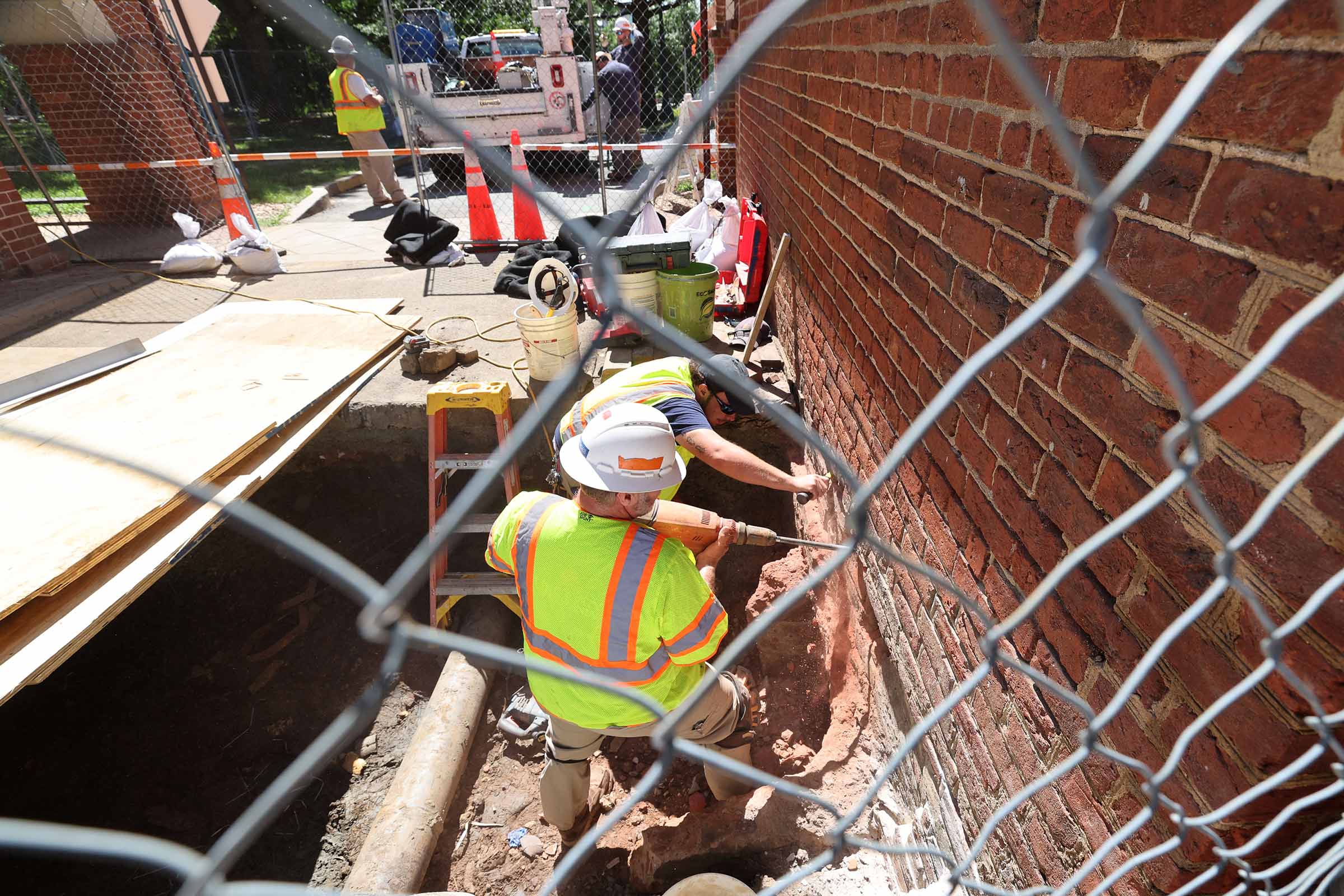 Facilities Management masons trained in working with historic fabric work on the foundation wall of 6 East Range. 