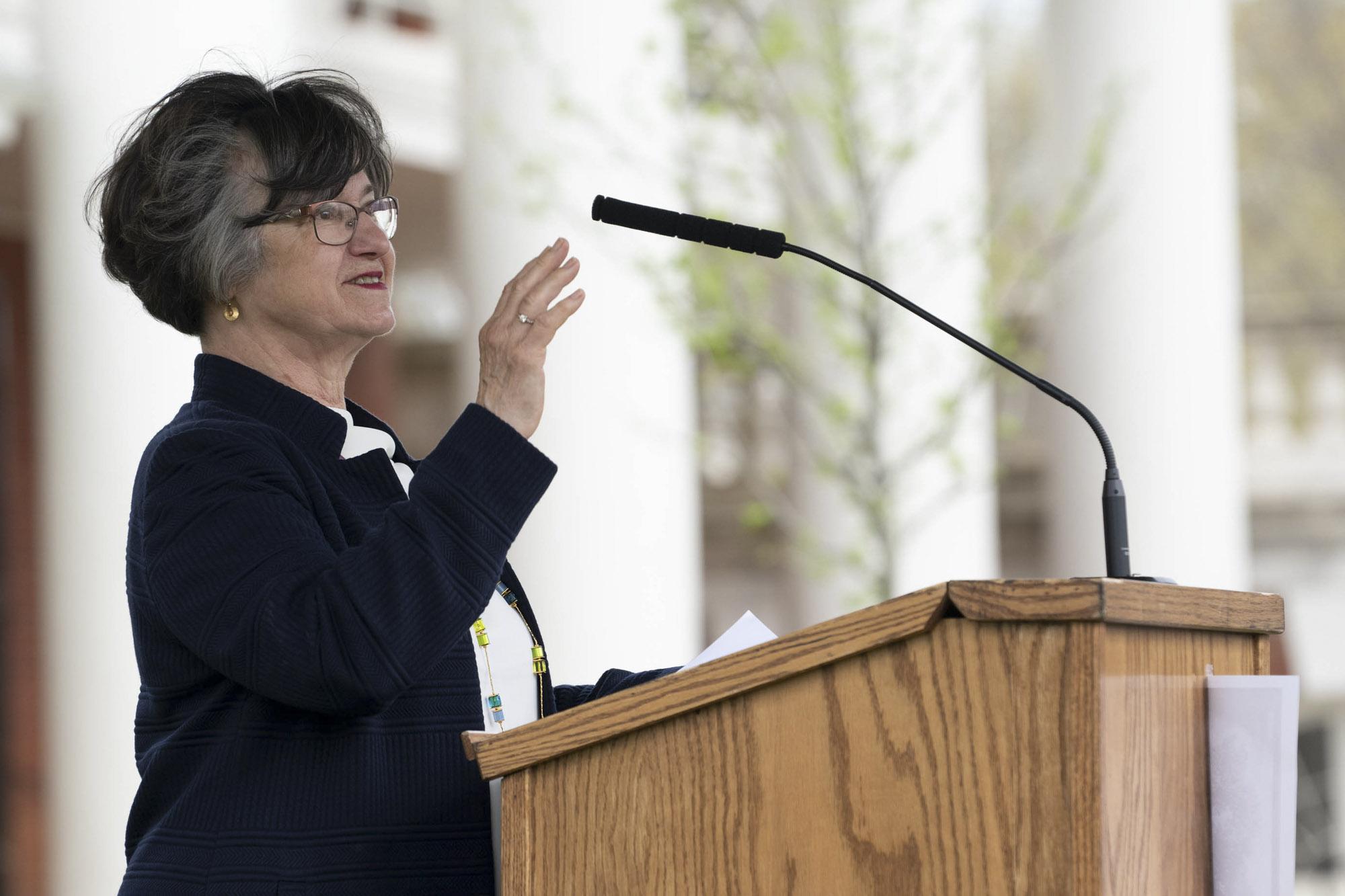 Mary Hughes speaks at a podium