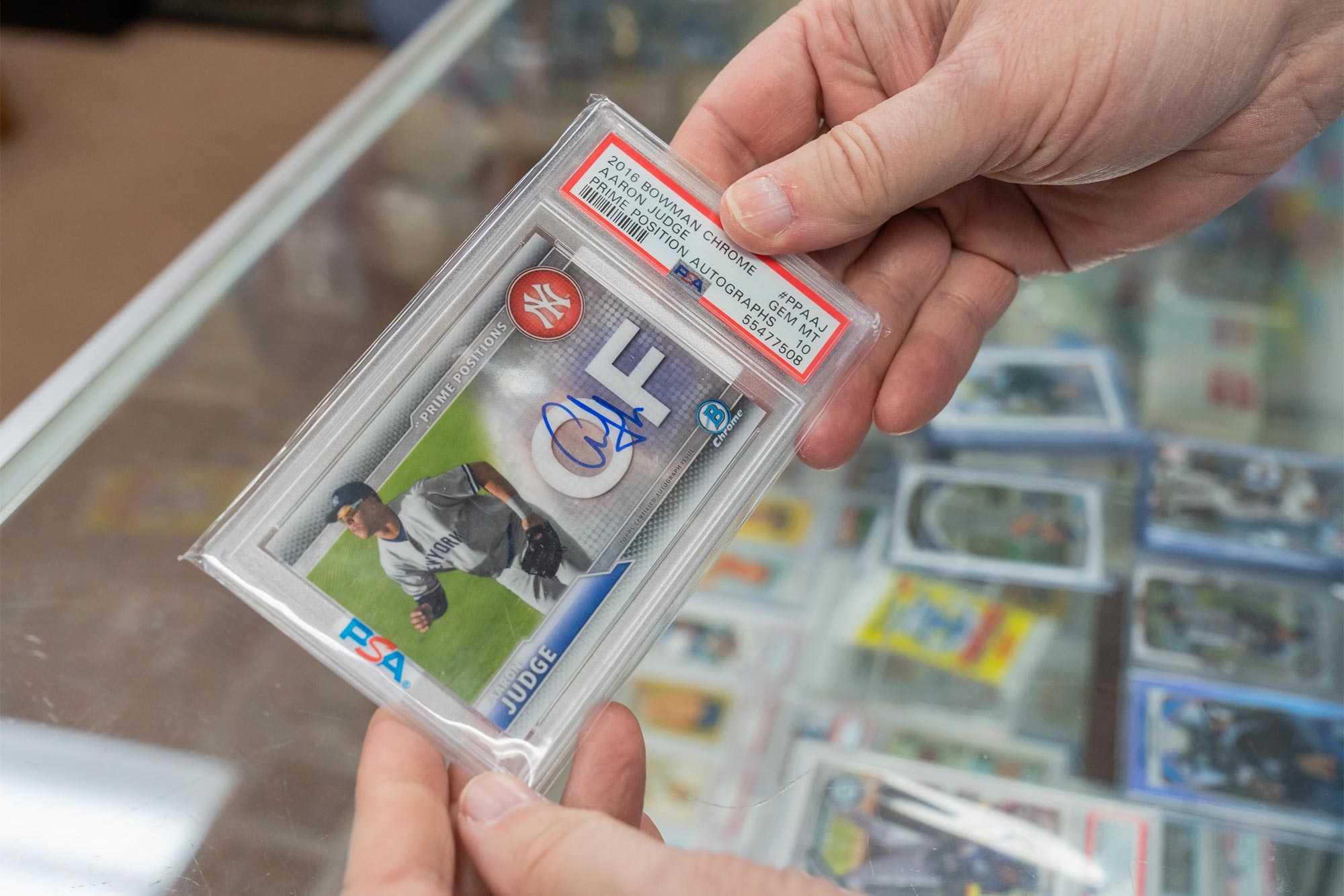 Prillaman holds a baseball card in a plastic case