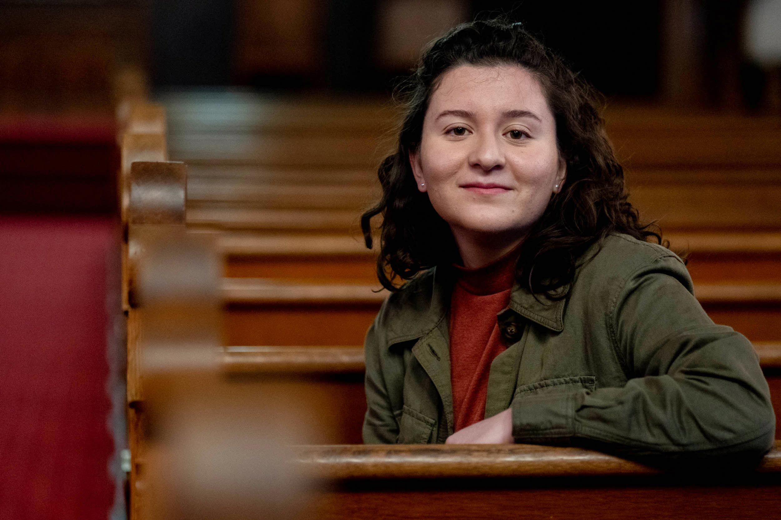 Martina Bucheli sits on a church pew in the UVA Chapel