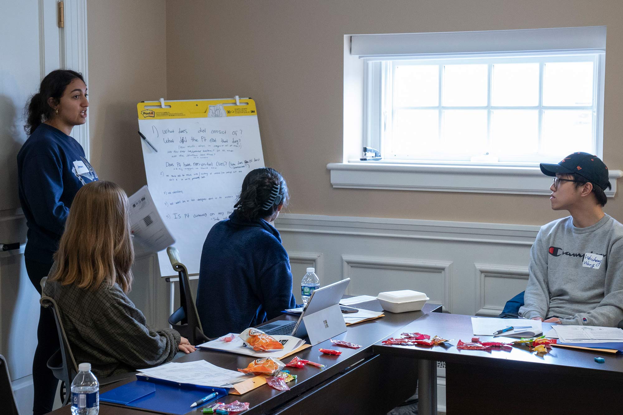 Student Amani Akkoub presenting a training scenario on a presentation notepad to her class