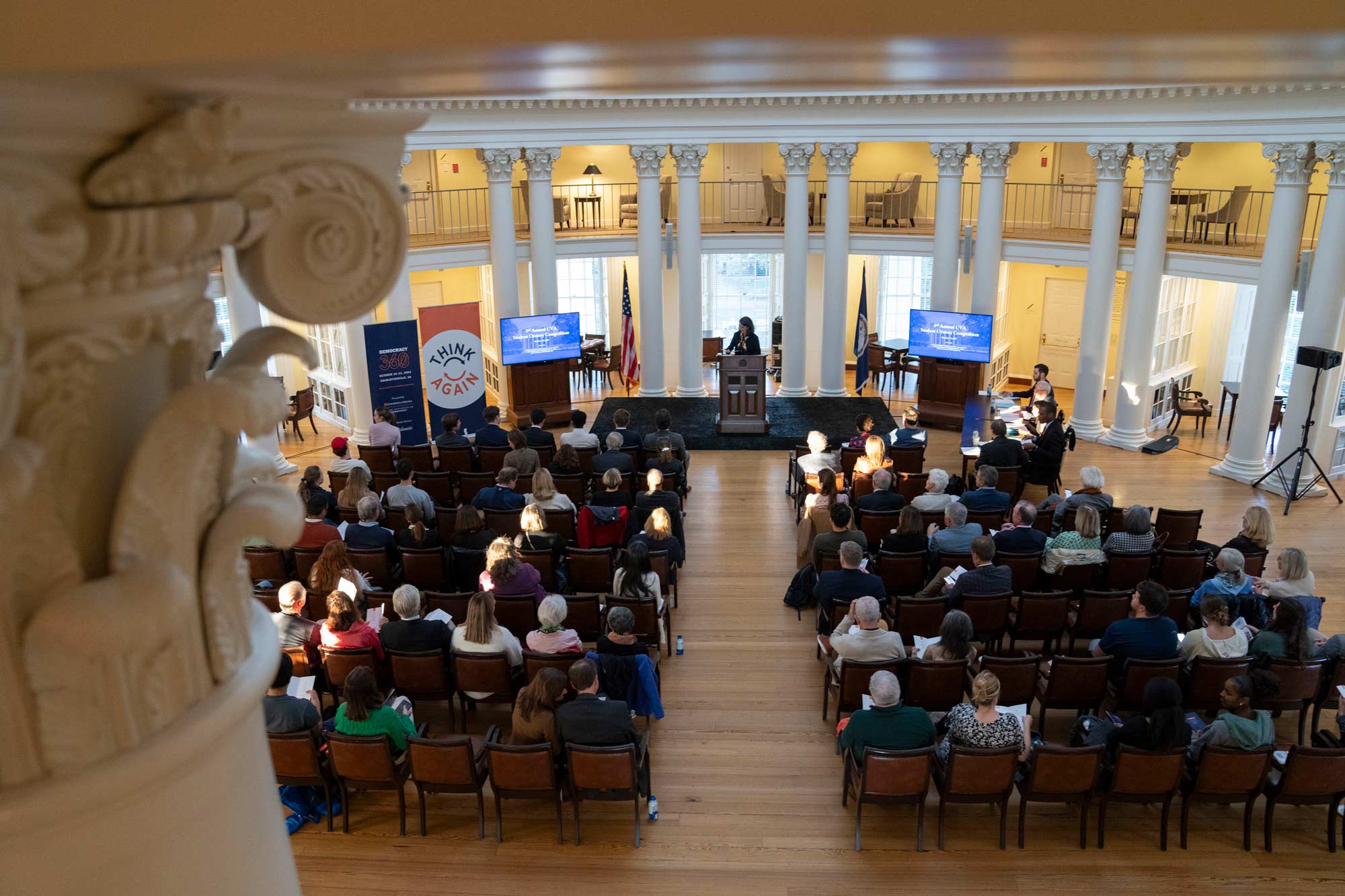 Above shot of the Rotunda dome room looking onto an audience and podium with a student speaker