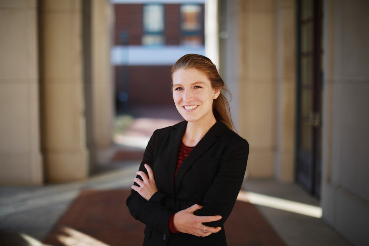 Meredith Kilburn stands with her arms crossed smiling at the camera