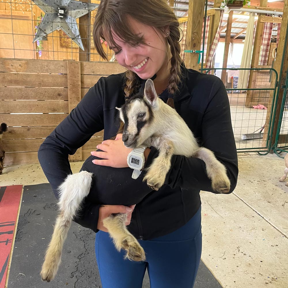 Lilly Brame holding a baby goat