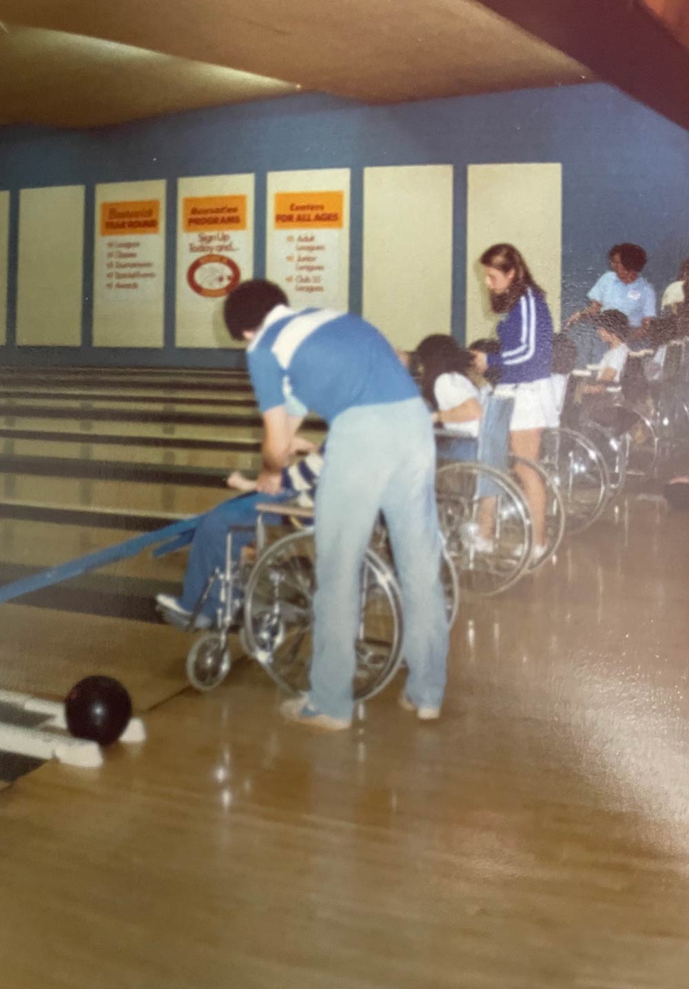 Martin Block assisting a competitor at wheelchair bowling