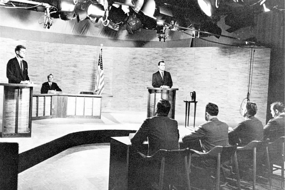 John F. Kennedy and Richard Nixon stand at podiums during a presidential debate